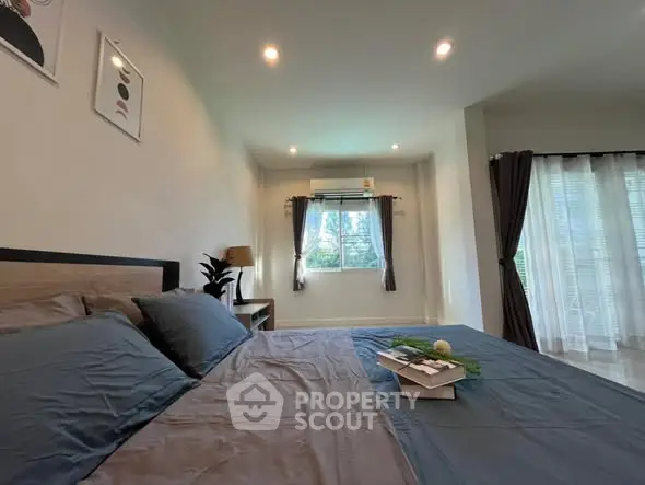 Spacious bedroom with modern decor and natural light