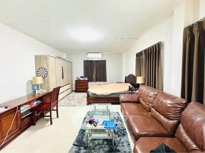 Spacious studio apartment with cozy living area and modern furnishings.