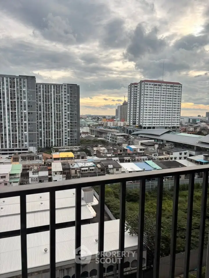 Stunning cityscape view from a high-rise balcony at sunset, showcasing urban living.