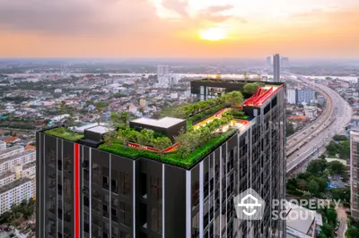 Stunning rooftop garden on modern high-rise with panoramic city views at sunset.