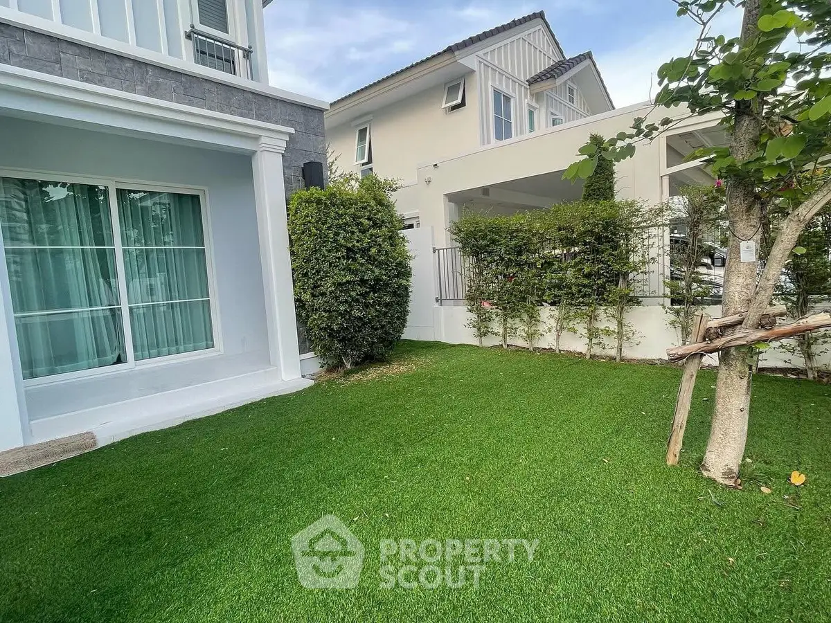 Charming suburban home with lush green garden and modern exterior design.