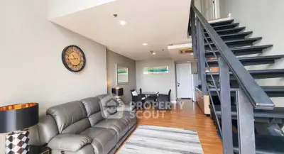 Spacious modern living room with stylish staircase and cozy seating area