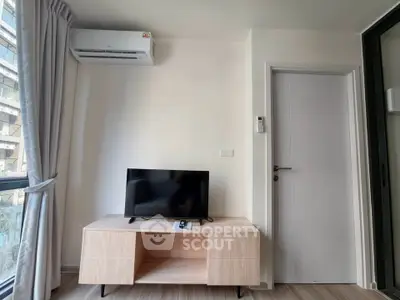 Modern living room with sleek TV stand and air conditioning in a stylish apartment.