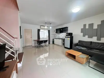 Spacious modern living room with open kitchen and sleek furnishings