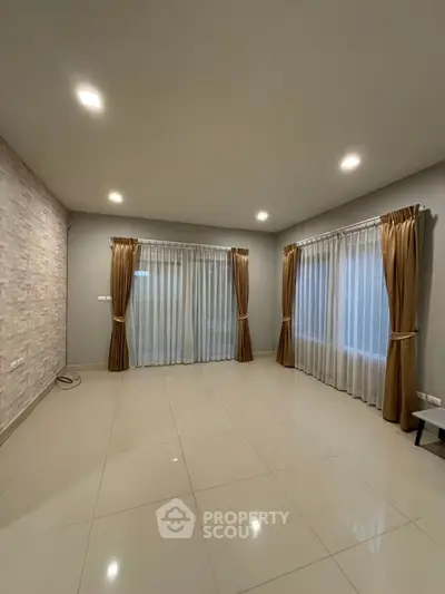 Spacious empty living room with elegant curtains and modern lighting