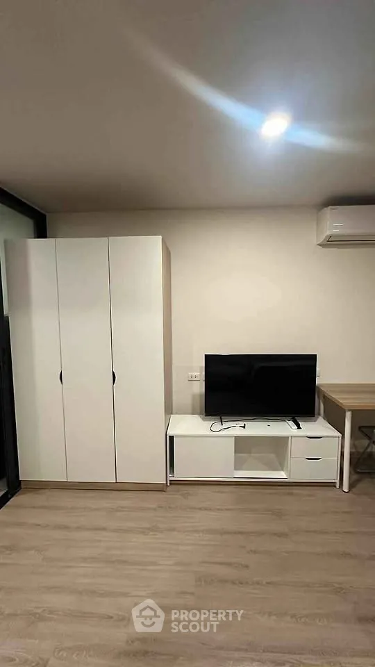 Modern living room with sleek furniture and air conditioning unit, perfect for comfortable living.