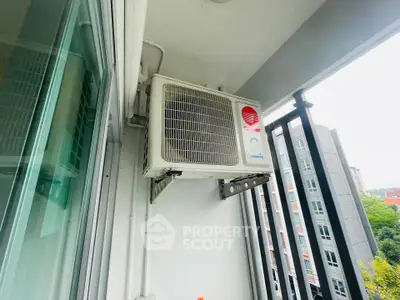 Modern apartment balcony with air conditioning unit and city view