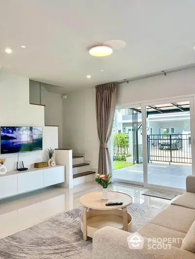 Modern living room with sleek design and natural light, featuring a cozy sofa and stylish decor.