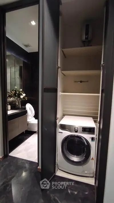 Modern bathroom with washing machine and sleek storage solutions
