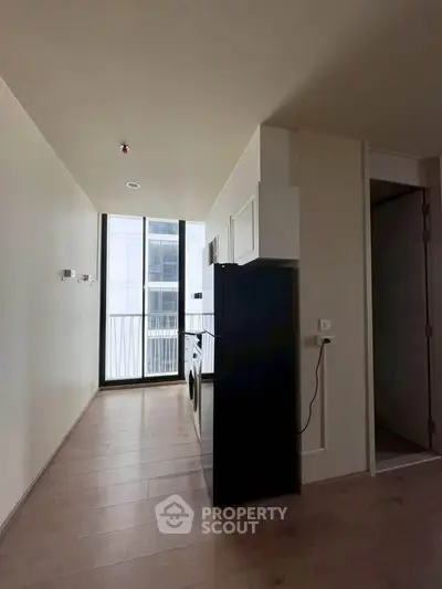 Modern apartment interior with sleek kitchen and large window view