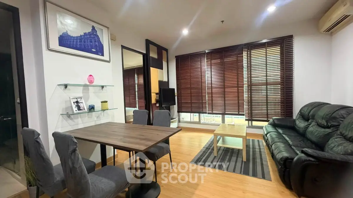 Modern living room with stylish furniture and large windows in a cozy apartment.