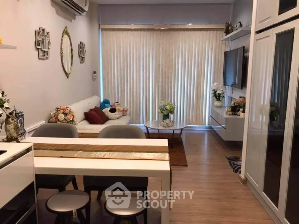 Modern living room with stylish decor and natural light, featuring a cozy seating area and elegant dining space.