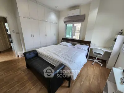 Spacious bedroom with modern furnishings and ample storage space