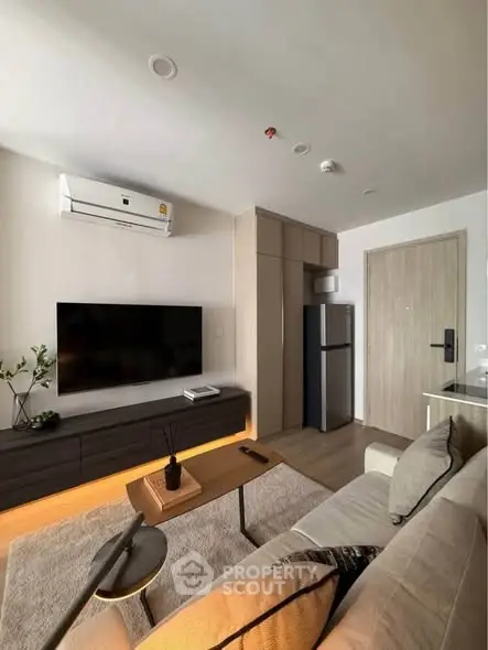 Modern living room with sleek furniture and wall-mounted TV, featuring a cozy ambiance.