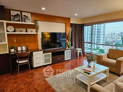 Spacious living room with city view, modern decor, and large windows.