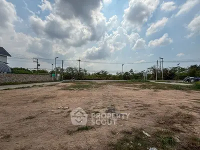 Spacious vacant land under a cloudy sky, ideal for development opportunities.