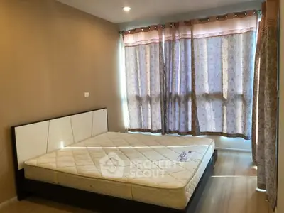 Spacious bedroom with large windows and natural light