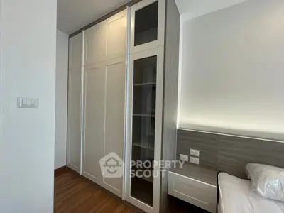 Modern bedroom with sleek built-in wardrobe and stylish wooden flooring