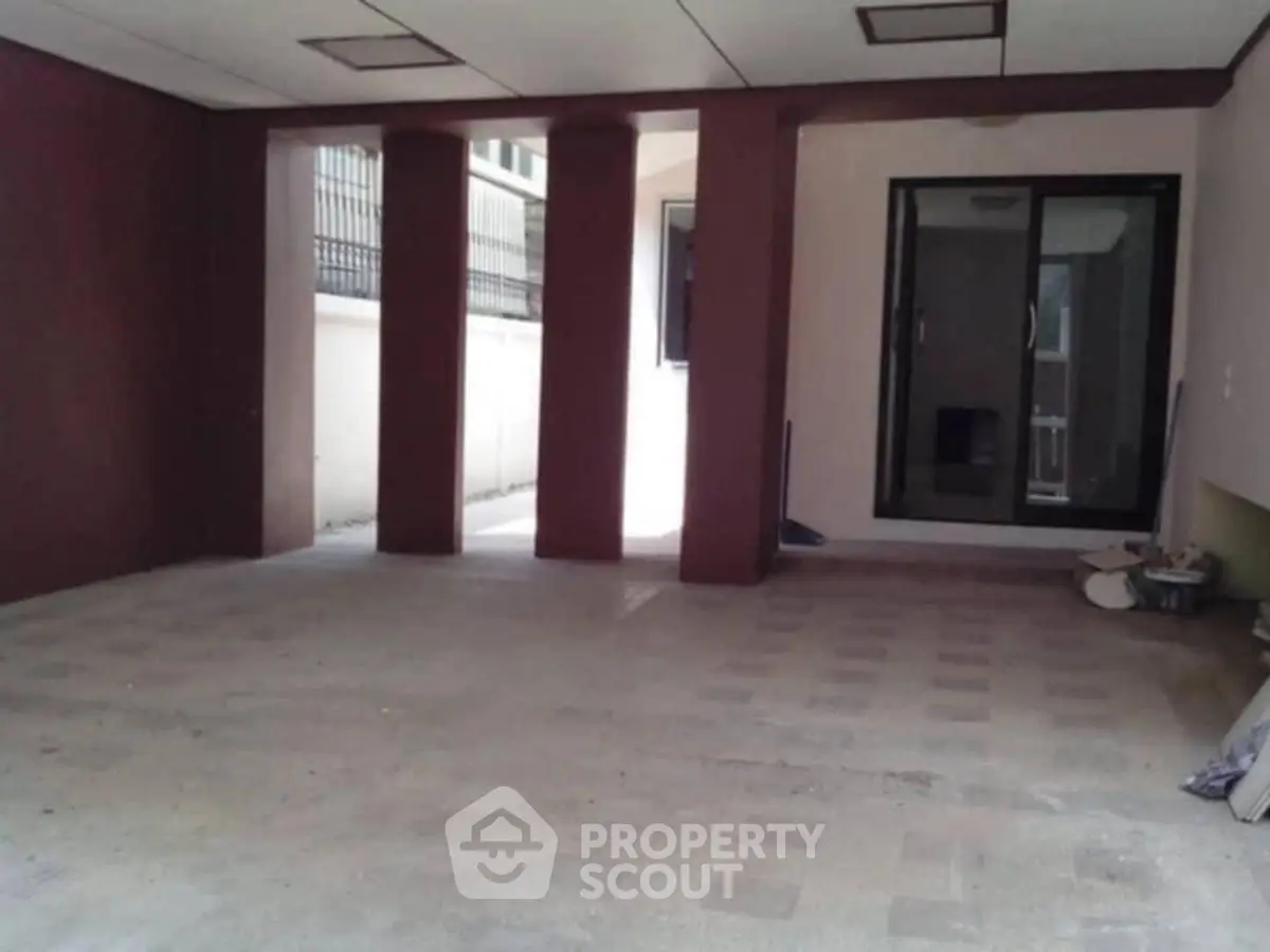 Spacious covered parking area with modern design and ample lighting.