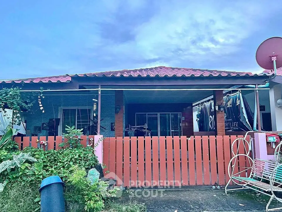 Charming single-story home with red roof and cozy front yard