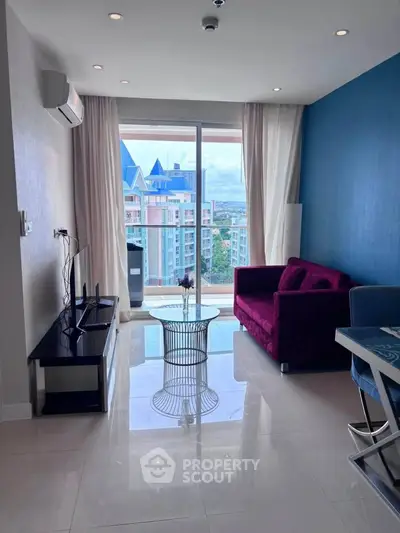 Modern living room with vibrant sofa and city view from balcony, perfect for urban living.