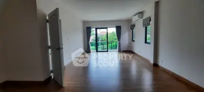 Spacious empty room with large windows and garden view, perfect for customization.