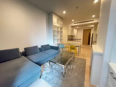 Modern open-plan living room with cozy seating and stylish kitchen area