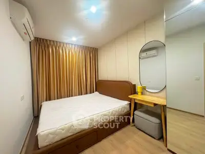 Cozy bedroom with modern decor, featuring a comfortable bed and stylish mirror.