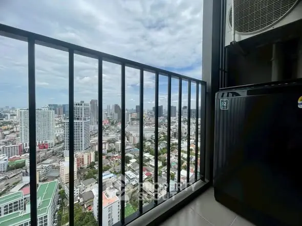 Stunning high-rise balcony view of city skyline with modern air conditioning unit.