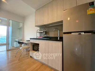 Modern kitchen with sleek cabinets and stainless steel appliances in a stylish apartment.