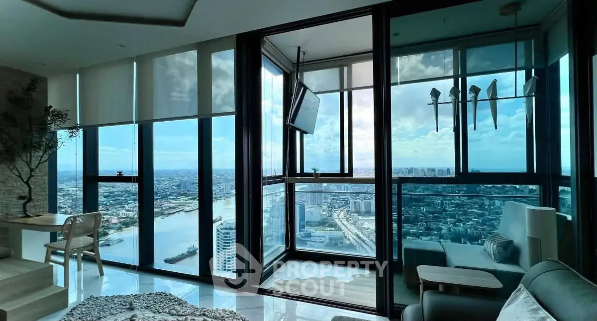Stunning high-rise apartment with panoramic city and river views, featuring modern interior and floor-to-ceiling windows.