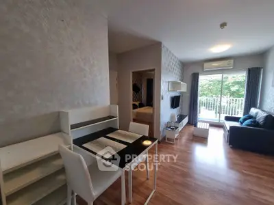 Modern open-plan living room with dining area and balcony view