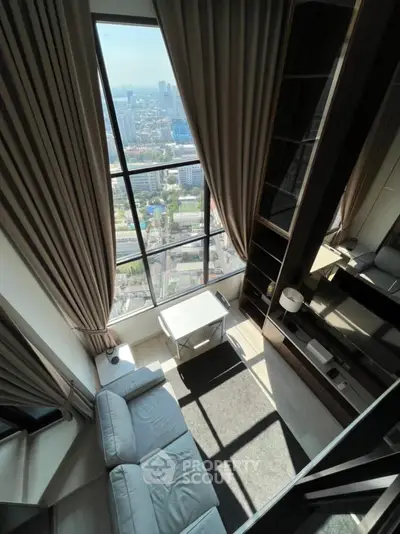 Luxurious high-rise living room with floor-to-ceiling windows and stunning city view
