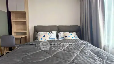 Cozy bedroom with modern decor and natural light, featuring a comfortable bed and study desk.