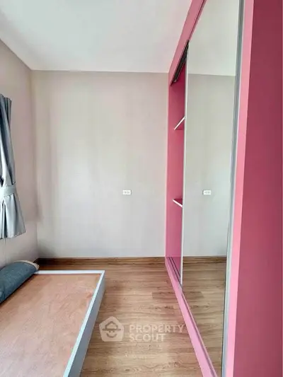Modern bedroom with pink accents and built-in wardrobe
