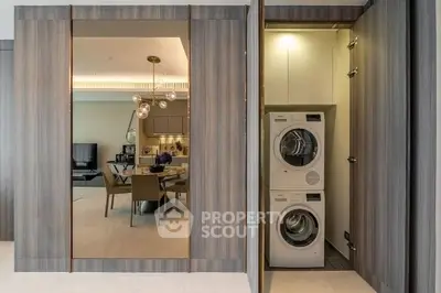 Modern apartment interior with open kitchen and laundry area