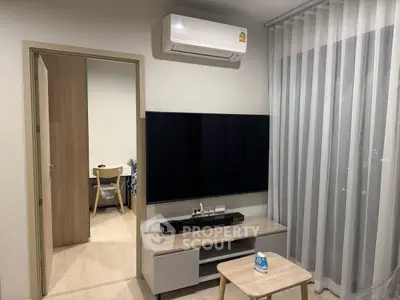 Modern living room with wall-mounted TV and air conditioning unit