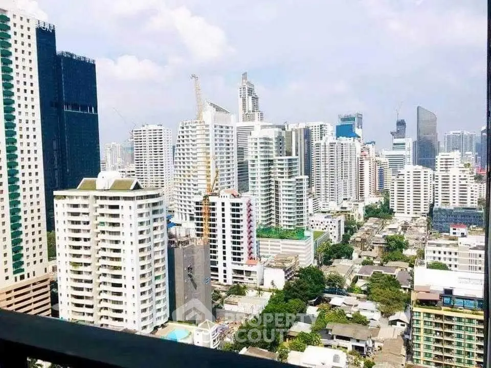 Stunning cityscape view from a high-rise balcony in a bustling urban area.