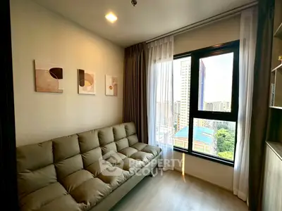 Modern living room with cozy sofa and large window offering city view