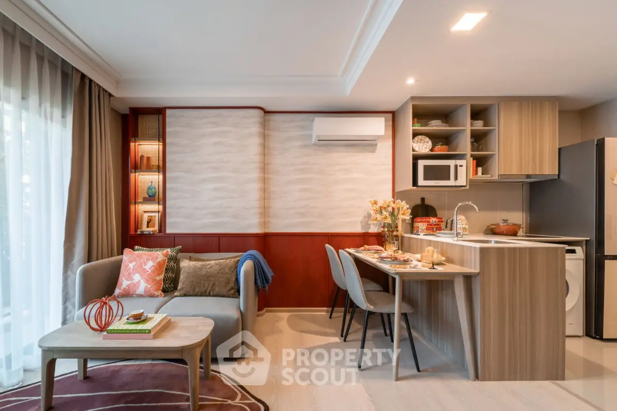 Modern open-plan living room and kitchen with stylish decor and natural light