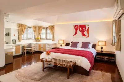 Spacious and elegant bedroom with cozy decor and ample natural light.