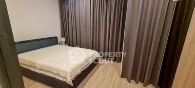 Cozy bedroom with modern decor and large windows for natural light