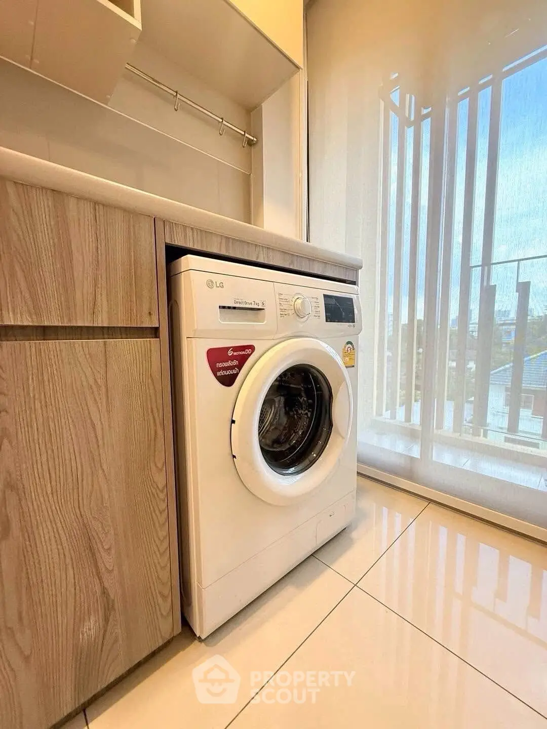 Modern laundry area with washing machine and sleek cabinetry