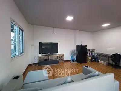 Spacious living room with modern decor and wooden flooring