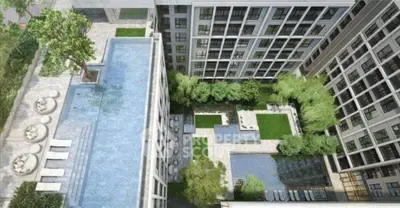 Luxurious aerial view of modern apartment complex with rooftop pool and lush garden courtyard.
