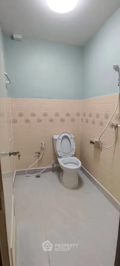 Spacious bathroom with modern fixtures and neutral tile design, perfect for comfort and functionality.
