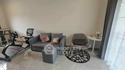 Modern living room with exercise bike and stylish furniture