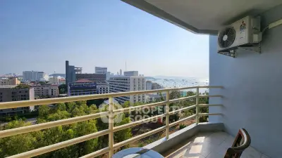 Stunning balcony view overlooking cityscape and ocean, perfect for relaxation and enjoying the scenery.
