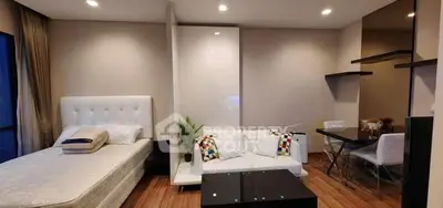 Modern studio apartment with cozy bed and stylish decor