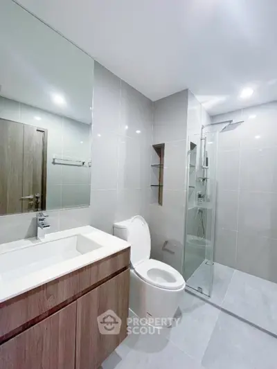 Modern bathroom with sleek fixtures and glass shower enclosure